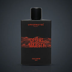 Black perfume bottle labeled 'Desert Majesty' by Uppernotes on a dark background