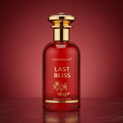 Red perfume bottle labeled 'Last Bliss' with gold accents on a red background