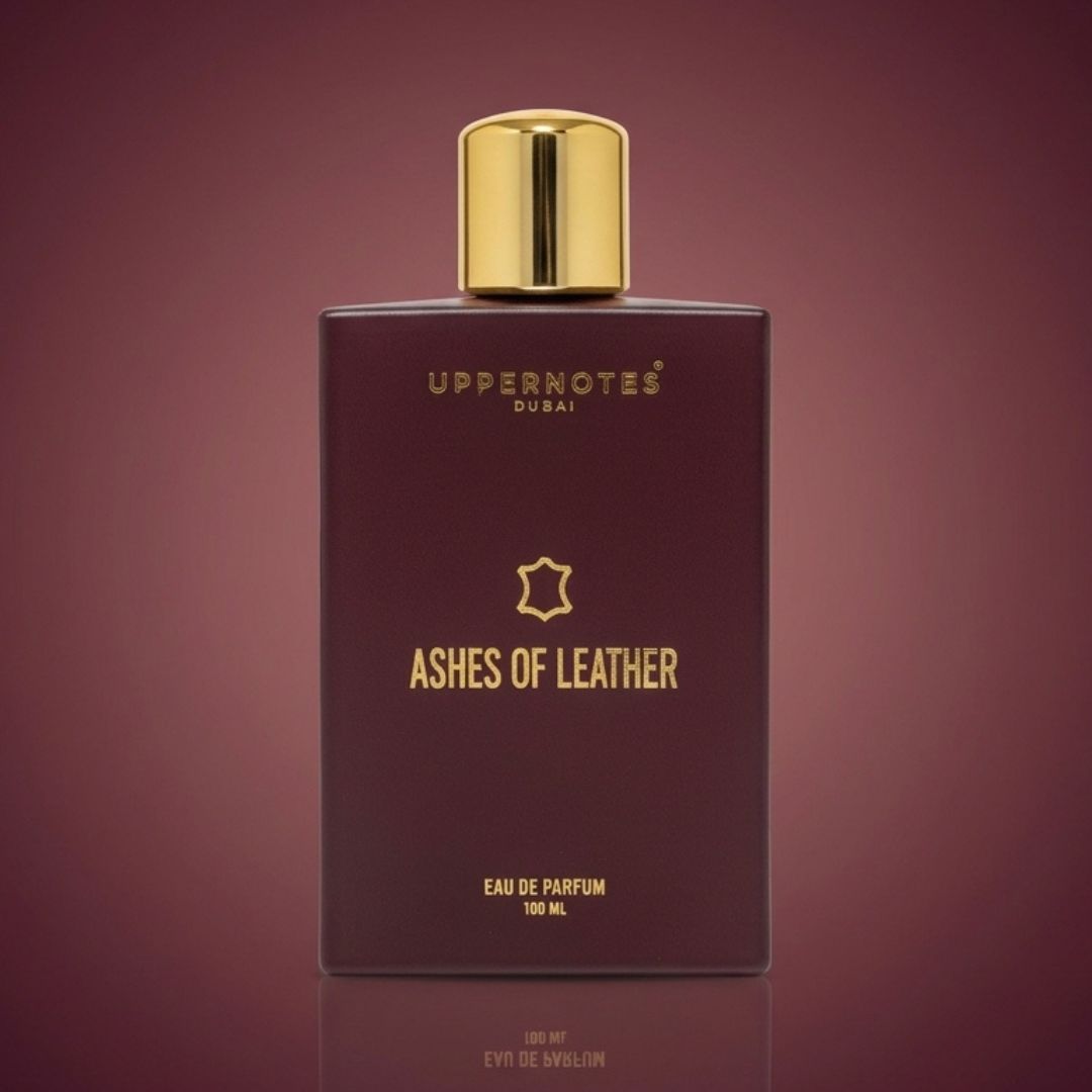 Perfume bottle labeled 'Ashes of Leather' by Uppernotes on a dark red background
