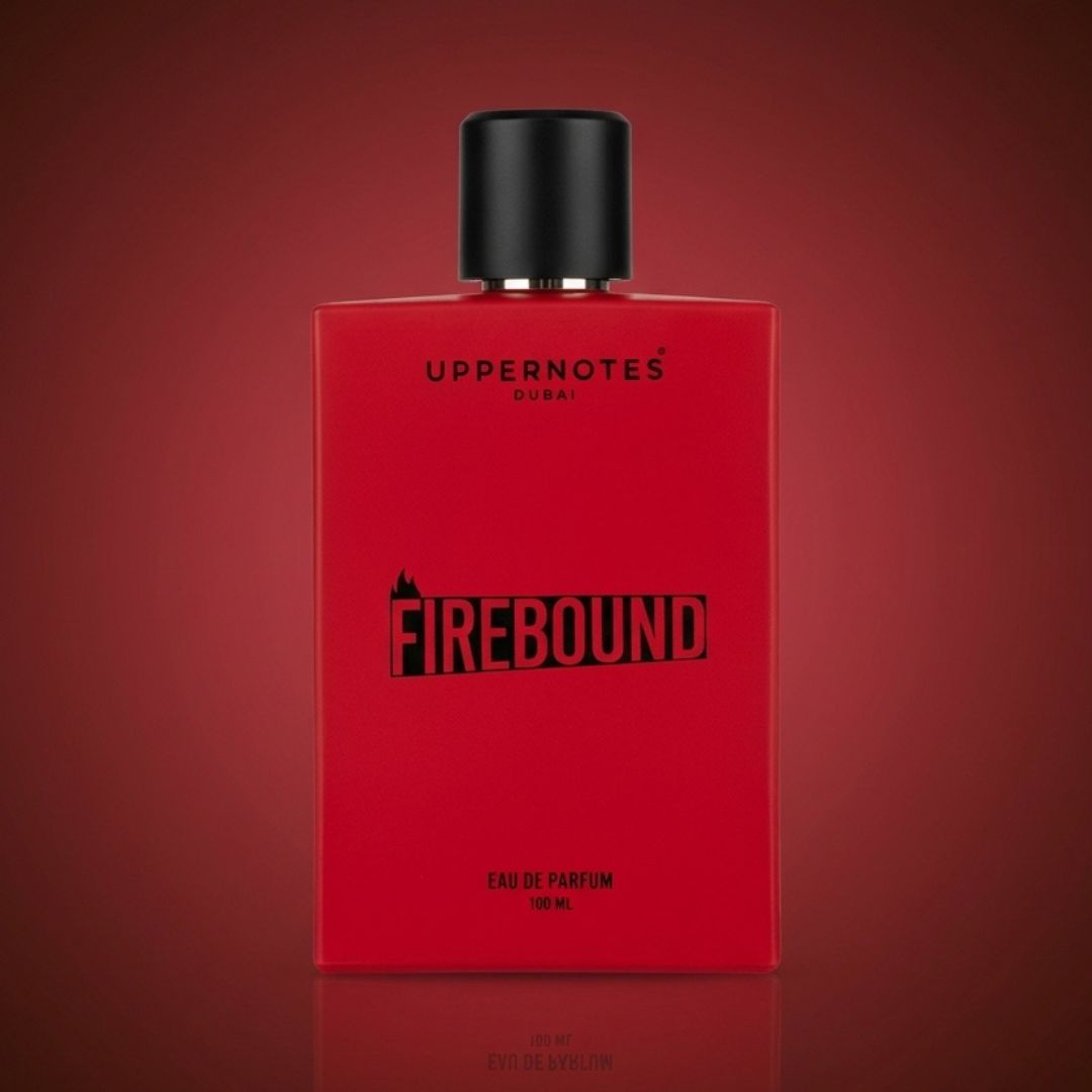 Red perfume bottle with black cap on a red background